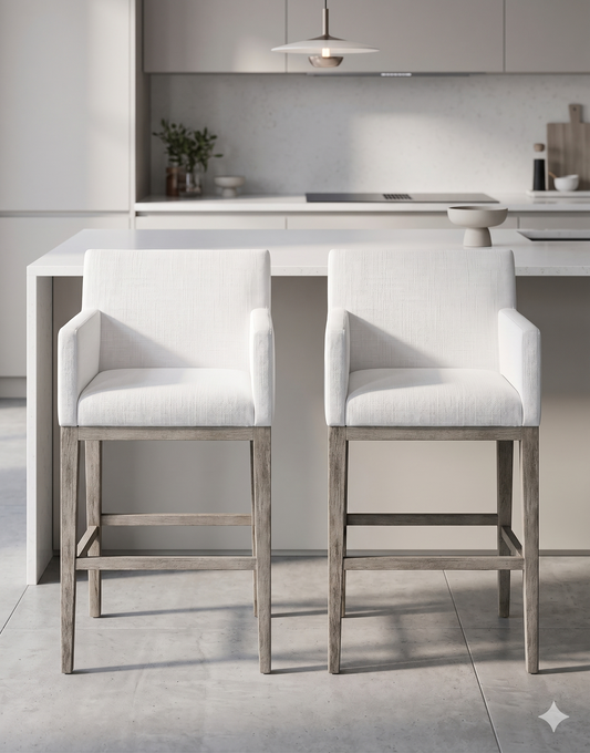 Banqueta alta de diseño contemporáneo con estructura de madera maciza en acabado natural. Presenta un asiento y respaldo integrado, tapizado en pana color claro con textura sutil. Incluye apoyapiés perimetral de madera para mayor estabilidad y confort