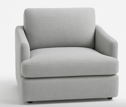 Sillón individual color gris con diseño moderno, apoyabrazos curvos y respaldo acolchado.