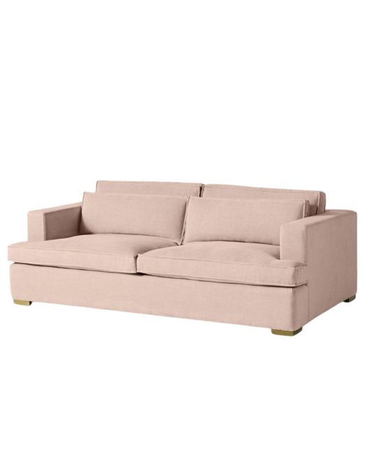 Sofá minimalista modelo Richard tapizado en pana, diseño rectangular de líneas limpias, amplios cojines y apoyabrazos rectos, patas bajas y estructura robusta, presentado sobre fondo blanco, perfecto para espacios modernos, livings relajados o ambientes de diseño escandinavo que buscan comodidad y estética.