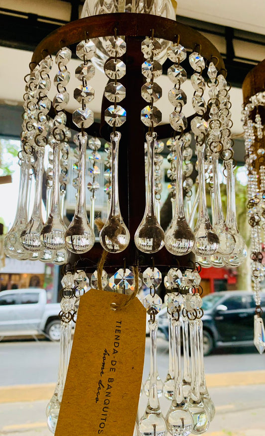 Araña colgante Amber con cristales transparentes largos y estructura circular metálica oscura.