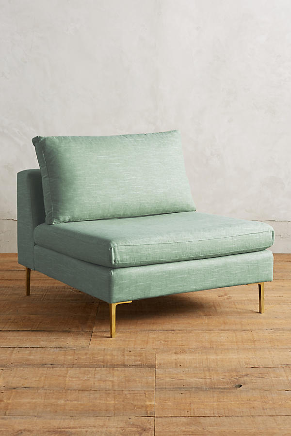 Módulo de sillón sin apoyabrazos en color verde claro, con respaldo alto y almohadón mullido, patas metálicas delgadas en tono dorado, sobre fondo blanco.
