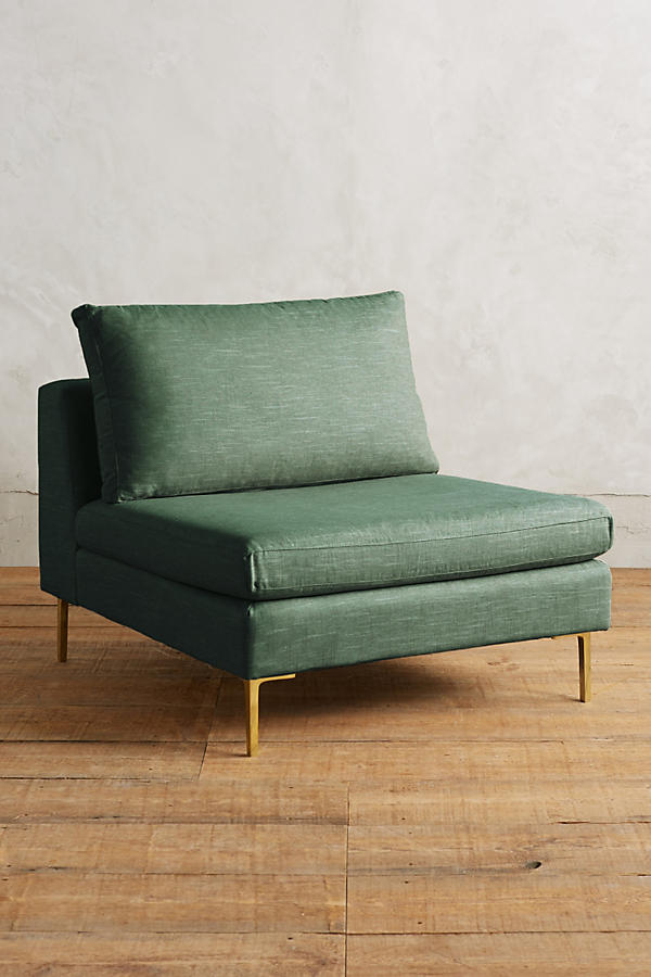 Módulo de sillón sin apoyabrazos en color verde, con respaldo alto y almohadón mullido, patas metálicas delgadas en tono dorado, sobre fondo blanco.