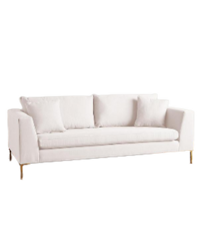 Sillón Bélgica de dos cuerpos con estructura recta, patas metálicas doradas finas, respaldo con almohadones sueltos y diseño atemporal. Estilo minimalista y acogedor.