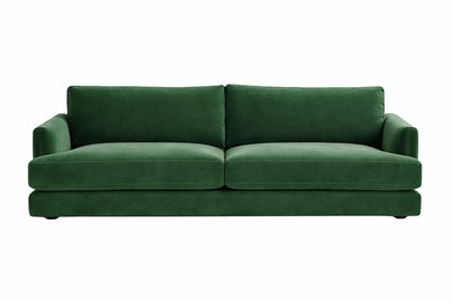 Una fotografía de diseño de interiores que muestra un living moderno y sofisticado de estilo nórdico-contemporáneo. En el centro está el sillón de dos cuerpos con tapizado texturizado gris claro, idéntico al de referencia. Está ubicado sobre una alfombra tejida gris y azul.