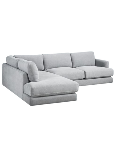 Sillón esquinero amplio en gris claro, almohadones grandes y asiento profundo. Confort máximo en estilo contemporáneo.