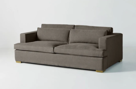 Sofá minimalista modelo Richard tapizado en pana, diseño rectangular de líneas limpias, amplios cojines y apoyabrazos rectos, patas bajas y estructura robusta, presentado sobre fondo blanco, perfecto para espacios modernos, livings relajados o ambientes de diseño escandinavo que buscan comodidad y estética.