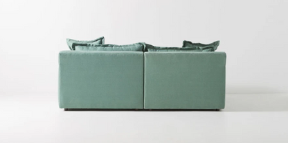 Sofá esquinero Enrique en color celeste verdoso con cojines estructurados y respaldo cómodo; oferta CyberMonday con descuentos y cuotas sin interés por tiempo limitado.

