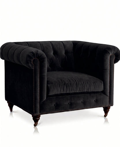 Sillón de un cuerpo Chesterfield color Black en pana antimanchas importada, el clásico diseño inglés firme con detalle de tachas — para un living con carácter que dure toda la vida. Hecho a medida por Tienda de Banquitos.