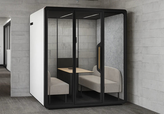 Cabina de reuniones Domo Meeting de Archivos Activos con dos sofás enfrentados y mesa, en una oficina