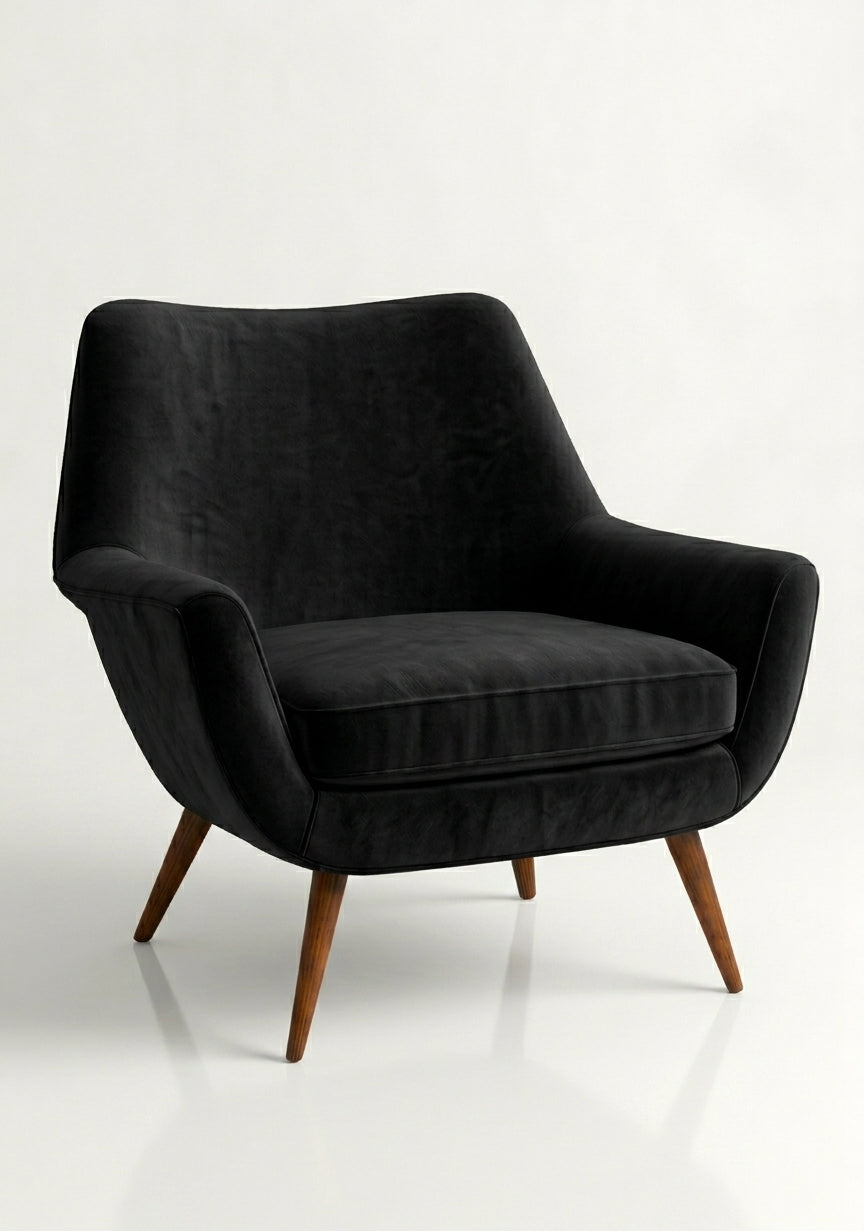 Sillón de un cuerpo Chloe color Black en pana antimanchas importada, respaldo curvo envolvente y patas de madera inclinadas de aire retro — ideal para sumar onda vintage al living. Hecho a medida por Tienda de Banquitos.