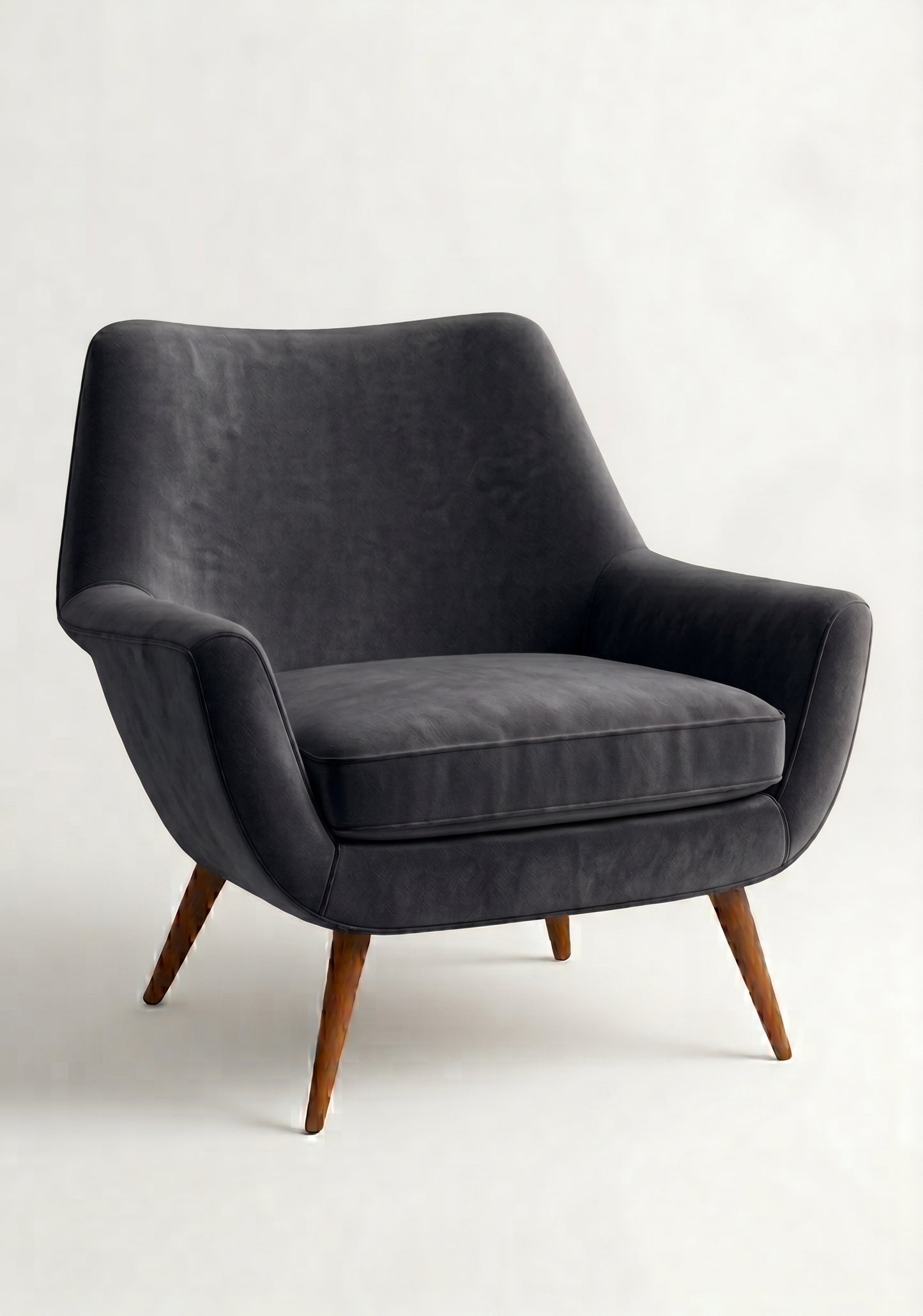 Sillón de un cuerpo Chloe color Grafito en pana antimanchas importada, respaldo curvo envolvente y patas de madera inclinadas de aire retro — ideal para sumar onda vintage al living. Hecho a medida por Tienda de Banquitos.