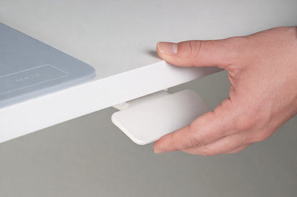 Mano accionando la palanca bajo la tapa del puesto elevable manual G1 de Archivos Activos
