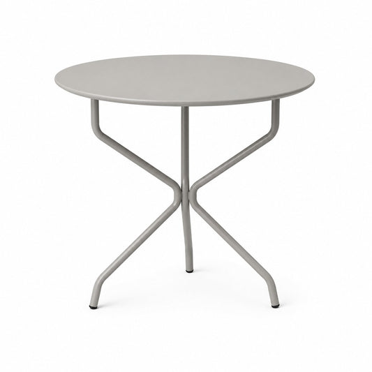 Mesa Cabo redonda fija en color gris, con patas de caño que se cruzan bajo la tapa