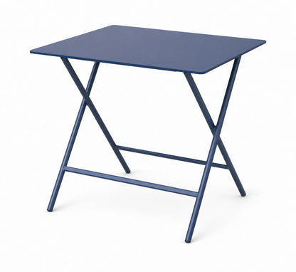 Mesa Prott cuadrada plegable azul, con patas en tijera de caño de acero y tapa del mismo color