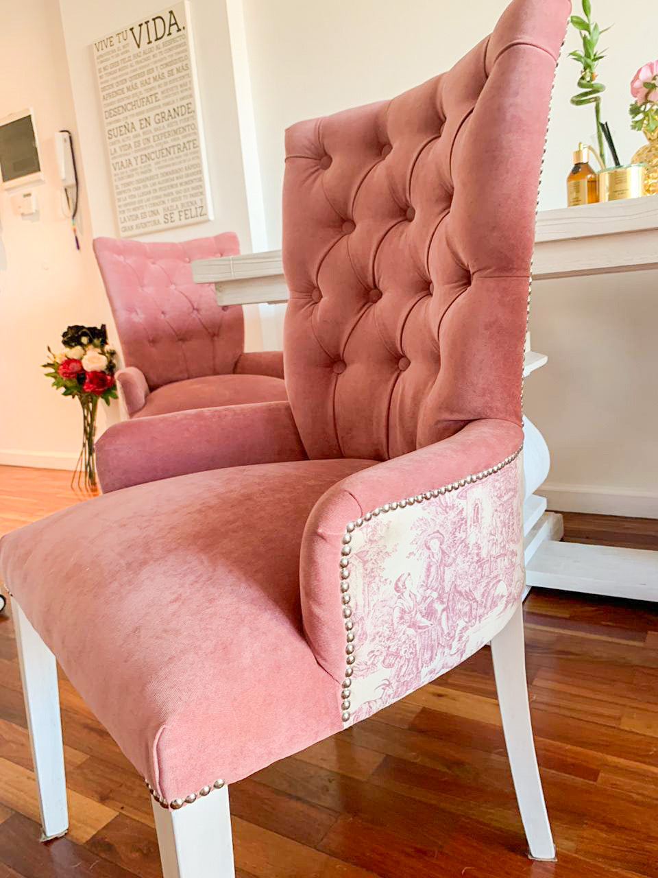 Sillas Menphis en velvet rosa con capitoné, exterior de los brazos en etoile francés y tachas plateadas, en el living de Victoria