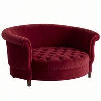 Sillón Brigitte redondo de Tienda de Banquitos tapizado en color bordo, con respaldo curvo envolvente y asiento capitoné