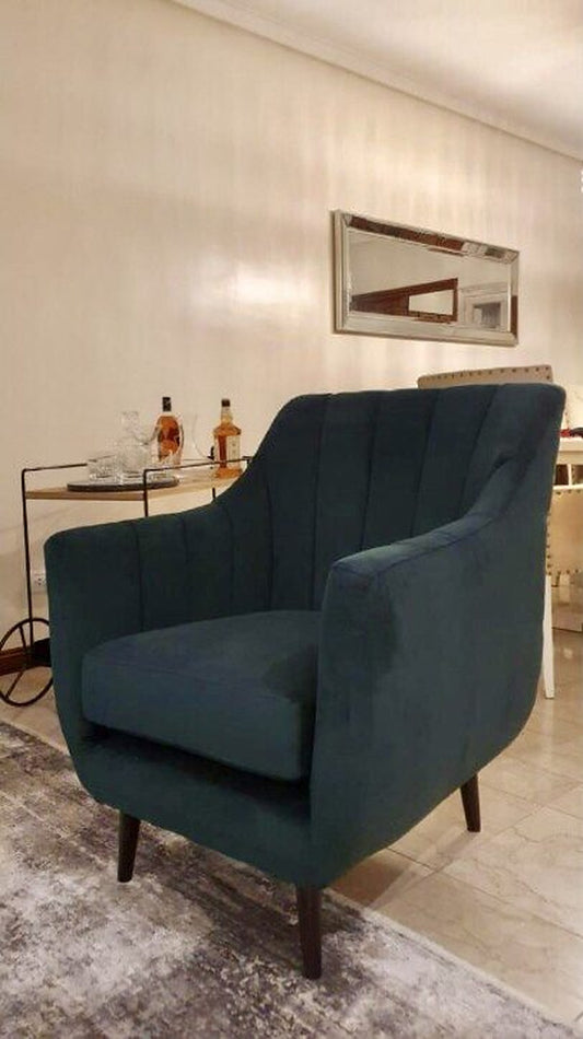 Sillón Collin verde inglés con canales verticales y patas de madera, en el living de Anabella en Coghlan
