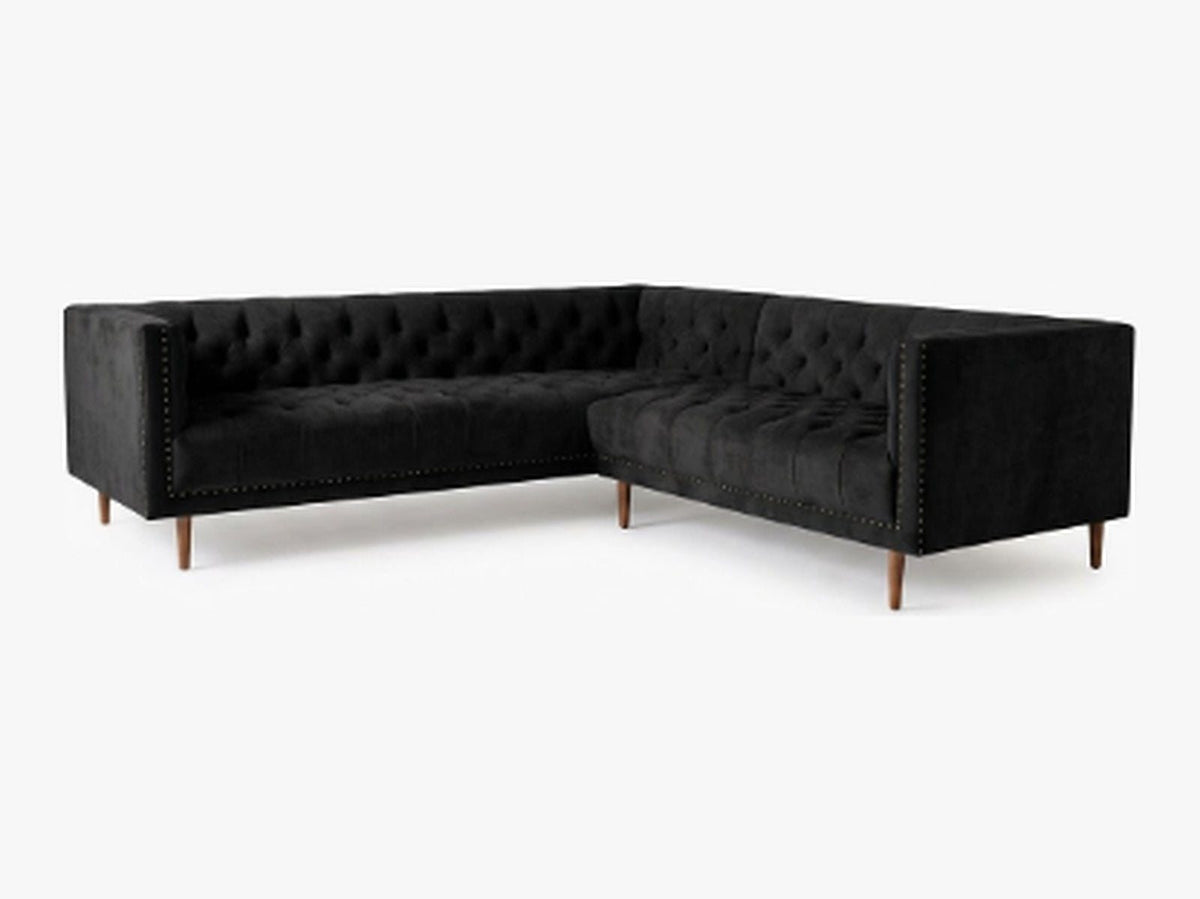 Sillón esquinero Bella Donna en pana antimanchas Black, forma en L, capitoné, borde con tachas y patas de madera