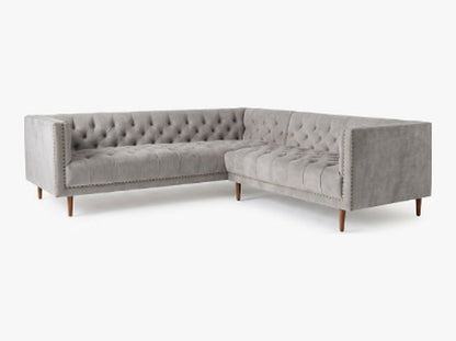Sillón esquinero Bella Donna en pana antimanchas Plata, forma en L, capitoné, borde con tachas y patas de madera