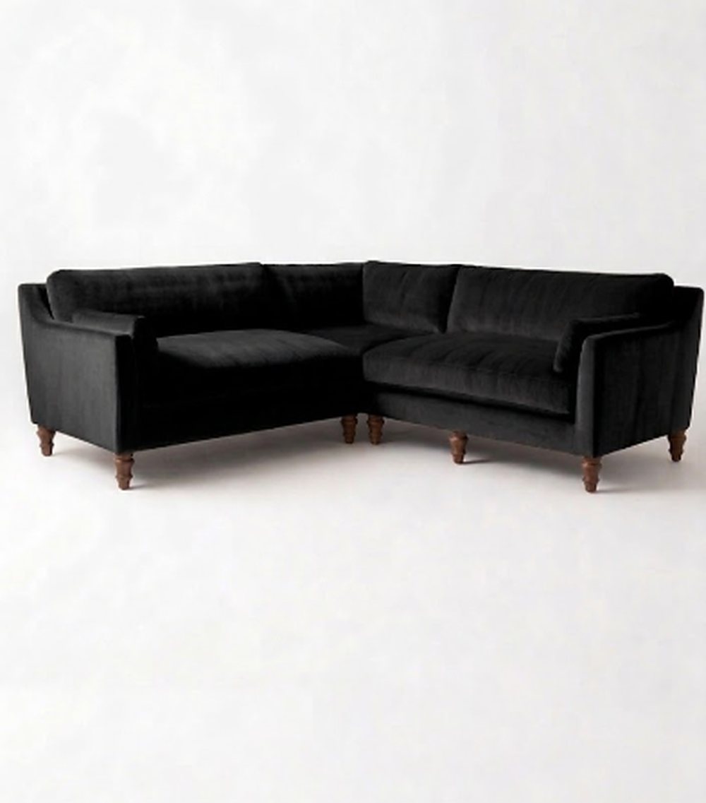 Sillón esquinero Leonelle en pana antimanchas Black, forma en L, almohadones y patas torneadas de madera
