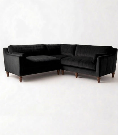 Sillón esquinero Leonelle en pana antimanchas Black, forma en L, almohadones y patas torneadas de madera