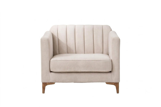 Sillón Mila de un cuerpo tapizado en crema, respaldo acanalado con apoyabrazos rectangulares y patas de aluminio dorado – Tienda de Banquitos