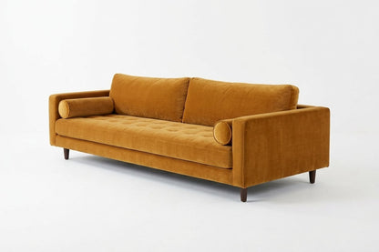 Sofá Bambú con botoné en el asiento y almohadones cilíndricos, en pana antimanchas color oro, imagen ilustrativa - Tienda de Banquitos