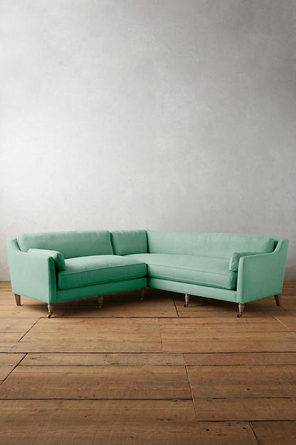 Sillón esquinero de diseño liviano en aqua, estructura baja y líneas minimalistas. Ideal para ambientes femeninos y luminosos.