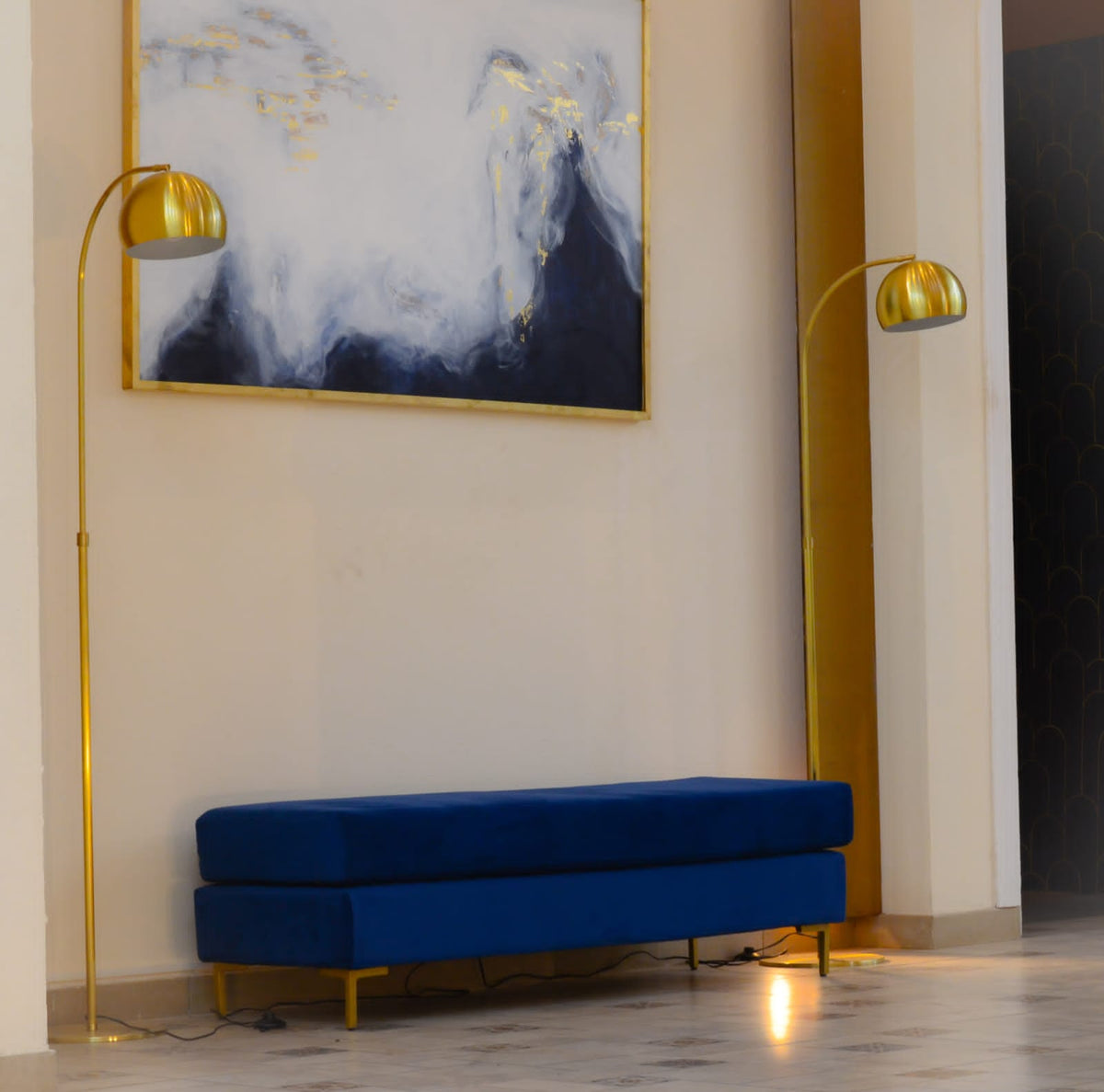 Banqueta Unique azul bajo un cuadro abstracto, en un salón de El Hotel de los Famosos 2022