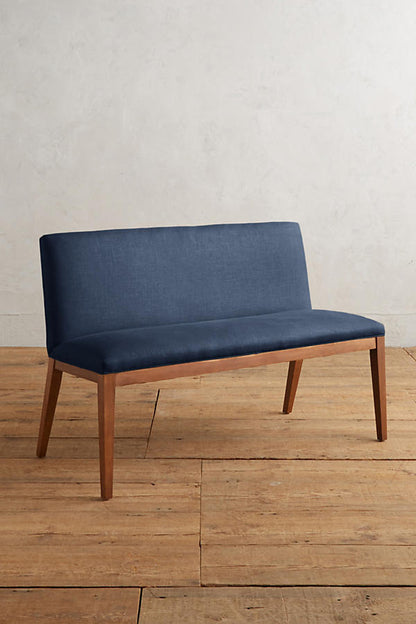 Silla Doble Nude tapizada en azul marino, con patas de madera