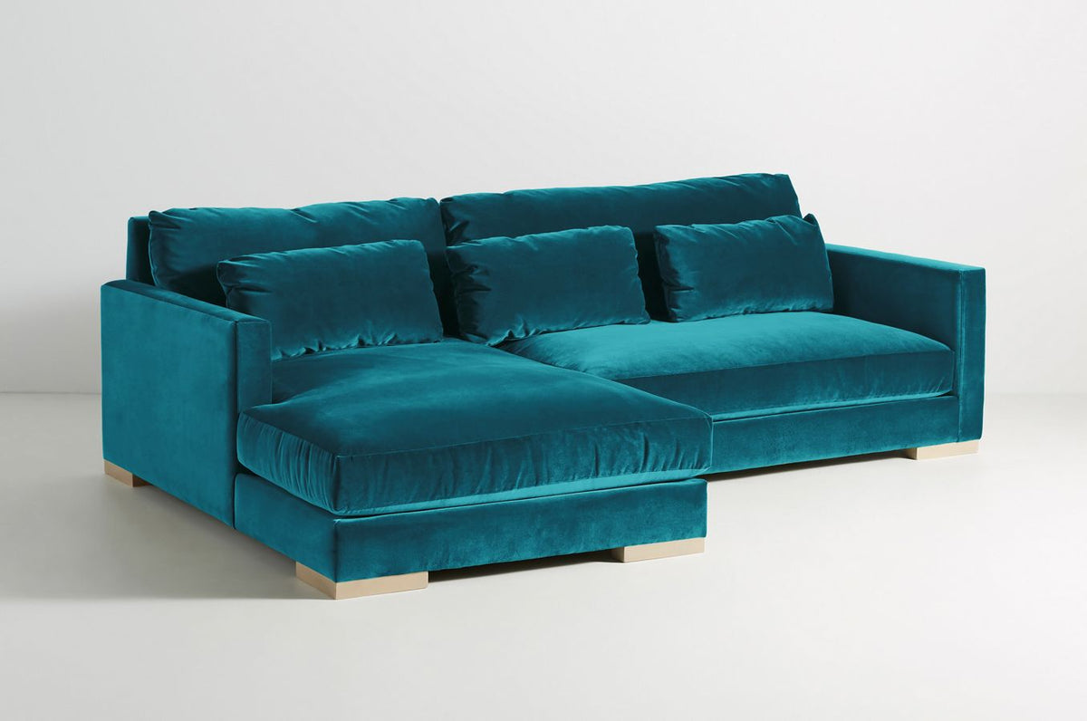 Sillón esquinero Steven en azul petróleo con respaldo alto y patas de madera